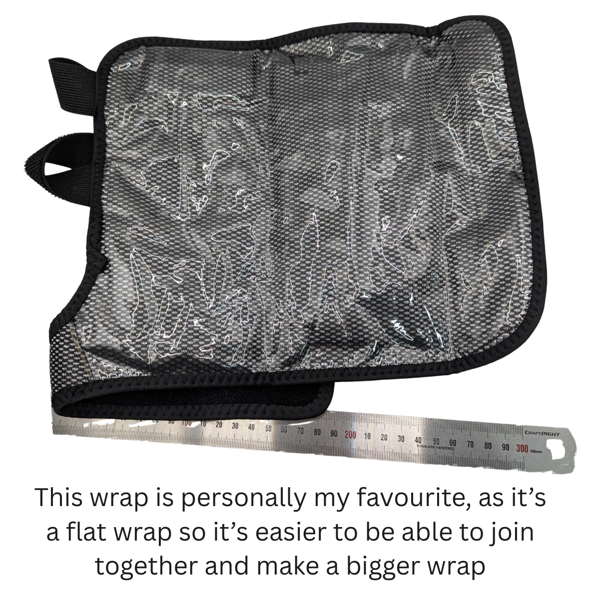A black mesh fabric wrap with black trim and a small black loop tab, shown on a white background with a metal ruler underneath for scale and a text caption at the bottom.