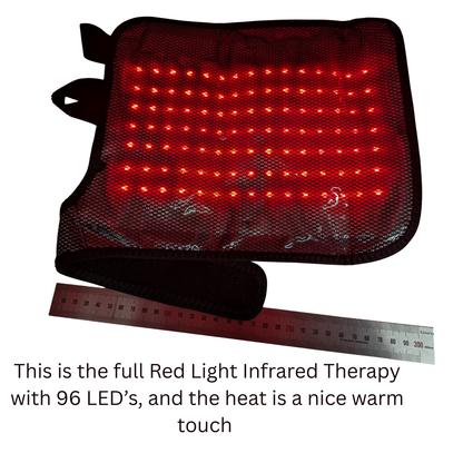 Red light therapy panel with a black mesh cover and wrist strap, shown with a ruler for scale and descriptive text below on a white background.